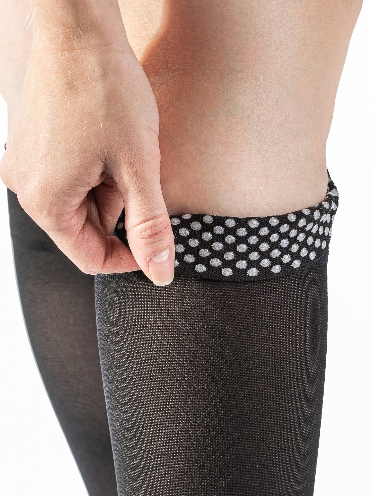 Closeup to show detail of the silicone dot grip-top band on Sigvaris Men's Essential Opaque compression stockings