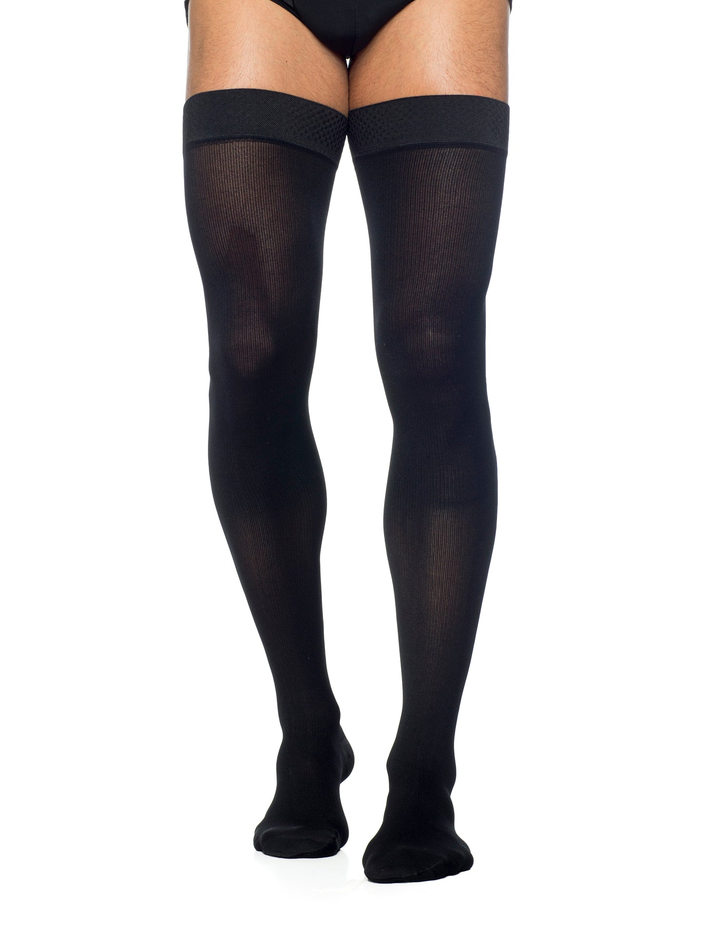 Man wearing Sigvaris Men's Essential Opaque compression thigh-highs in the color Black