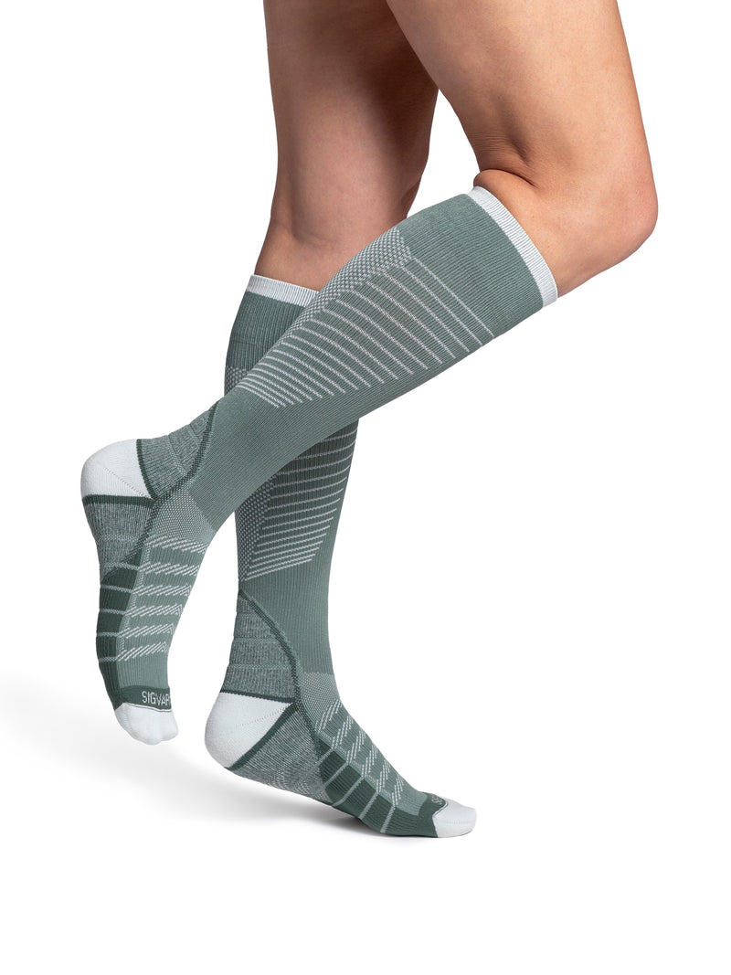 Woman wearing Sigvaris Motion Flow Tech compression socks in the color Sage
