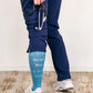Nurse standing to show the back of Sigvaris Well-being Microfiber Shades compression socks in the color Nurse Blue