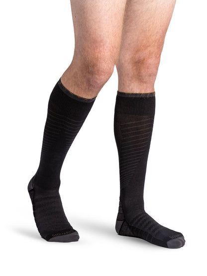Man wearing Sigvaris Men's Motion Flow Tech compression socks in the color Black