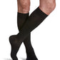 Man wearing Sigvaris Men's Style Microfiber compression socks with grip-top in the color Black