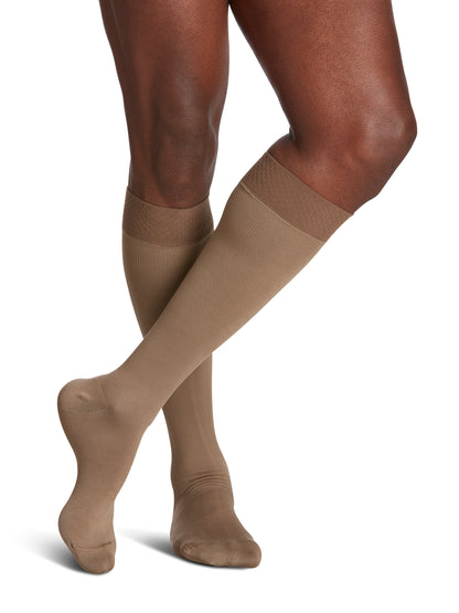 Man wearing Sigvaris Men's Style Microfiber compression socks with grip-top in the color Tan Khaki