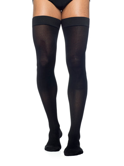 Man wearing Sigvaris Men's Essential Opaque compression thigh-highs in the color Black