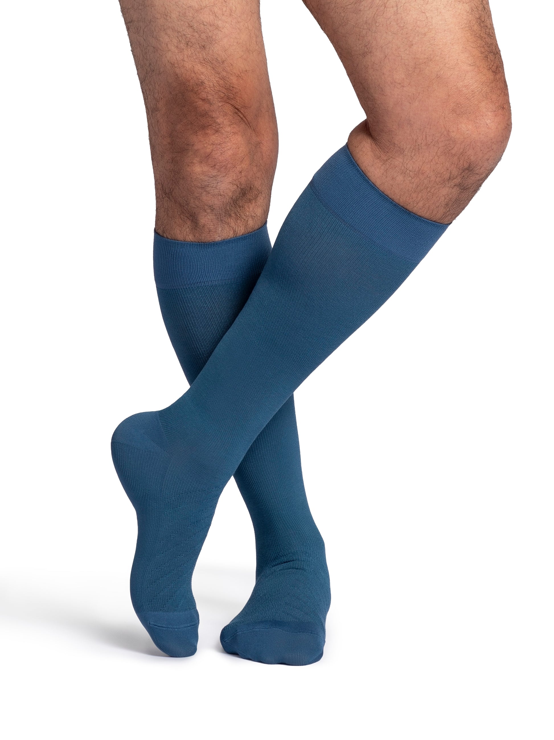 Man wearing Sigvaris Style Bamboo compression socks in the color Stone Blue