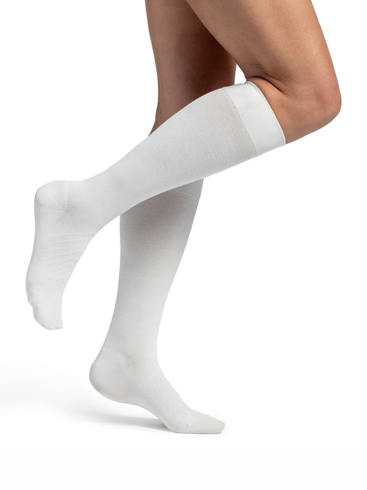 Woman wearing Sigvaris Style Bamboo compression socks in the color Ivory