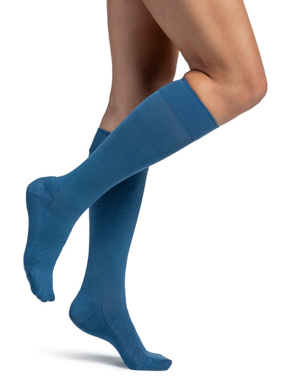 Woman wearing Sigvaris Style Bamboo compression socks in the color Stone Blue