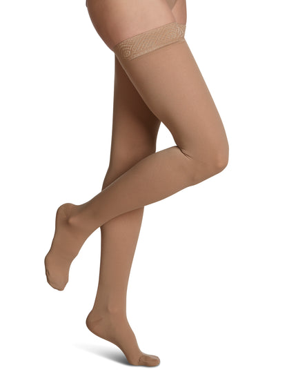 Woman wearing Sigvaris Women's Essential Opaque compression thigh-highs in the color Golden