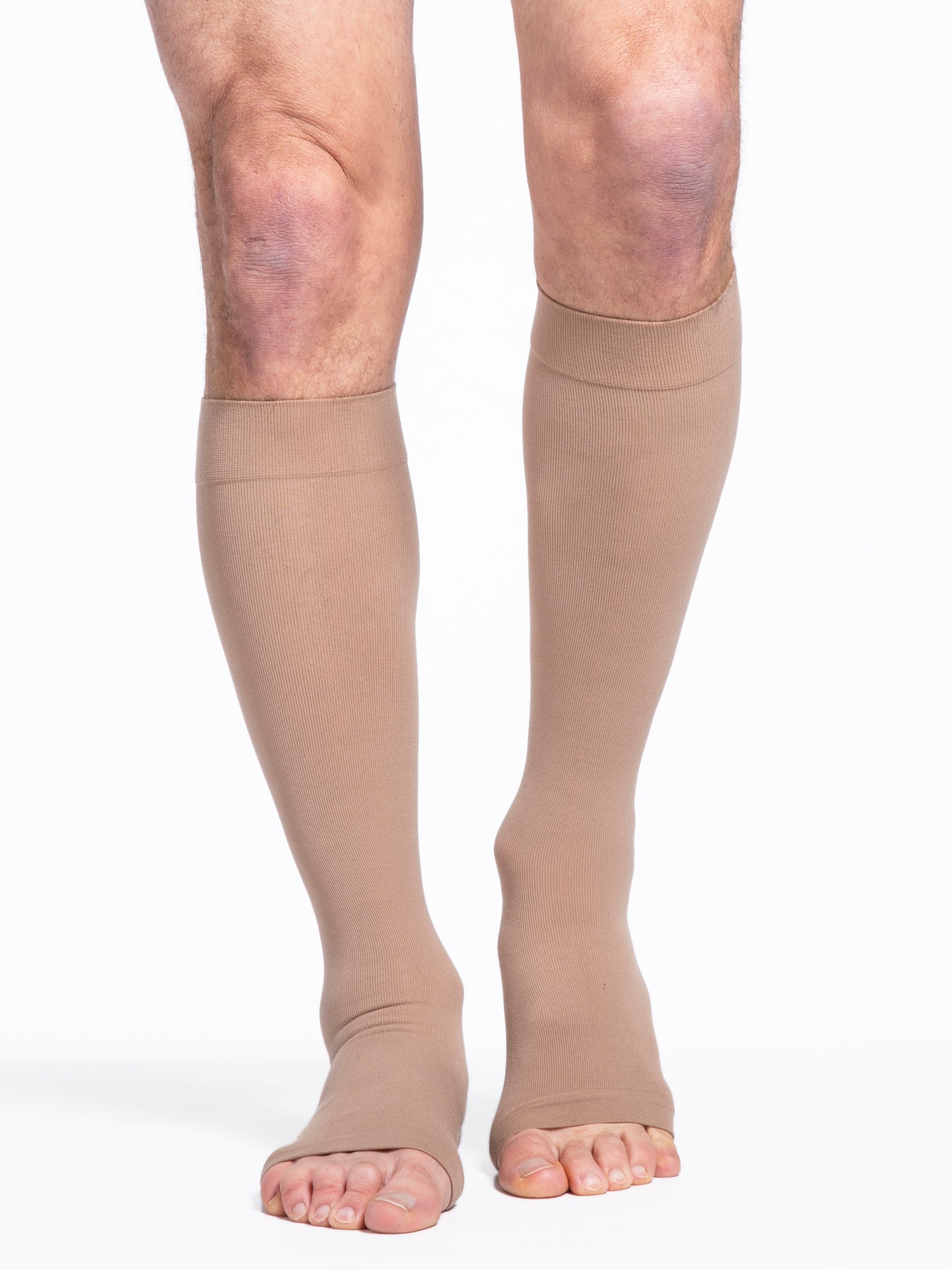 Man wearing Sigvaris Essential Cotton Open-Toe compression stockings in the color Light Beige