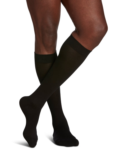 Man wearing Sigvaris Men's Sea Island Cotton compression socks in the color Black