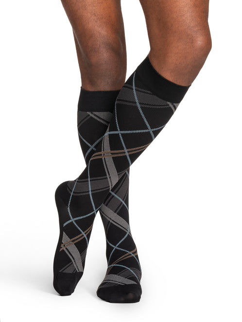 Man wearing Sigvaris Style Microfiber Patterns compression socks in the color Black Plaid