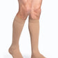 Man wearing Sigvaris Men's Essential Opaque calf plus with grip-top in the color Light Beige