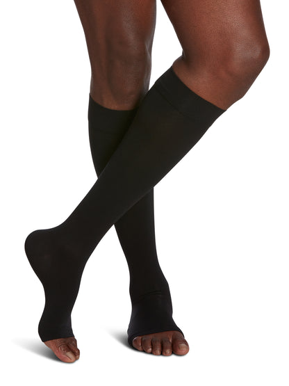 Man wearing Sigvaris Men's Essential Opaque open-toe compression socks in the color Black