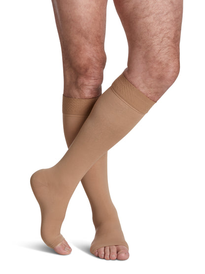 Man wearing Sigvaris Essential Opaque open-toe compression socks with grip-top in the color Light Beige