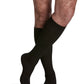 Man wearing Sigvaris Men's Casual Cotton compression socks in the color Black